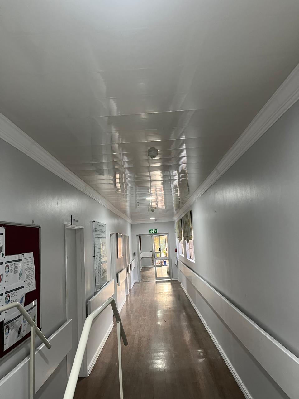 Finished corridor with repaired ceiling and wall detailing