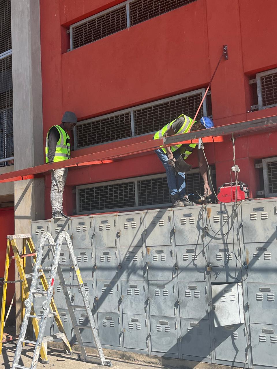 Team working on an exterior installation above lockers