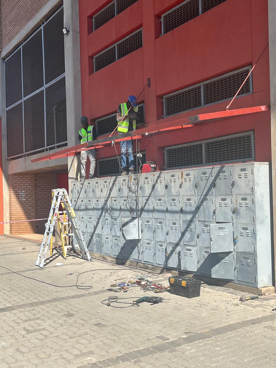 Team carrying out high-level exterior installation work