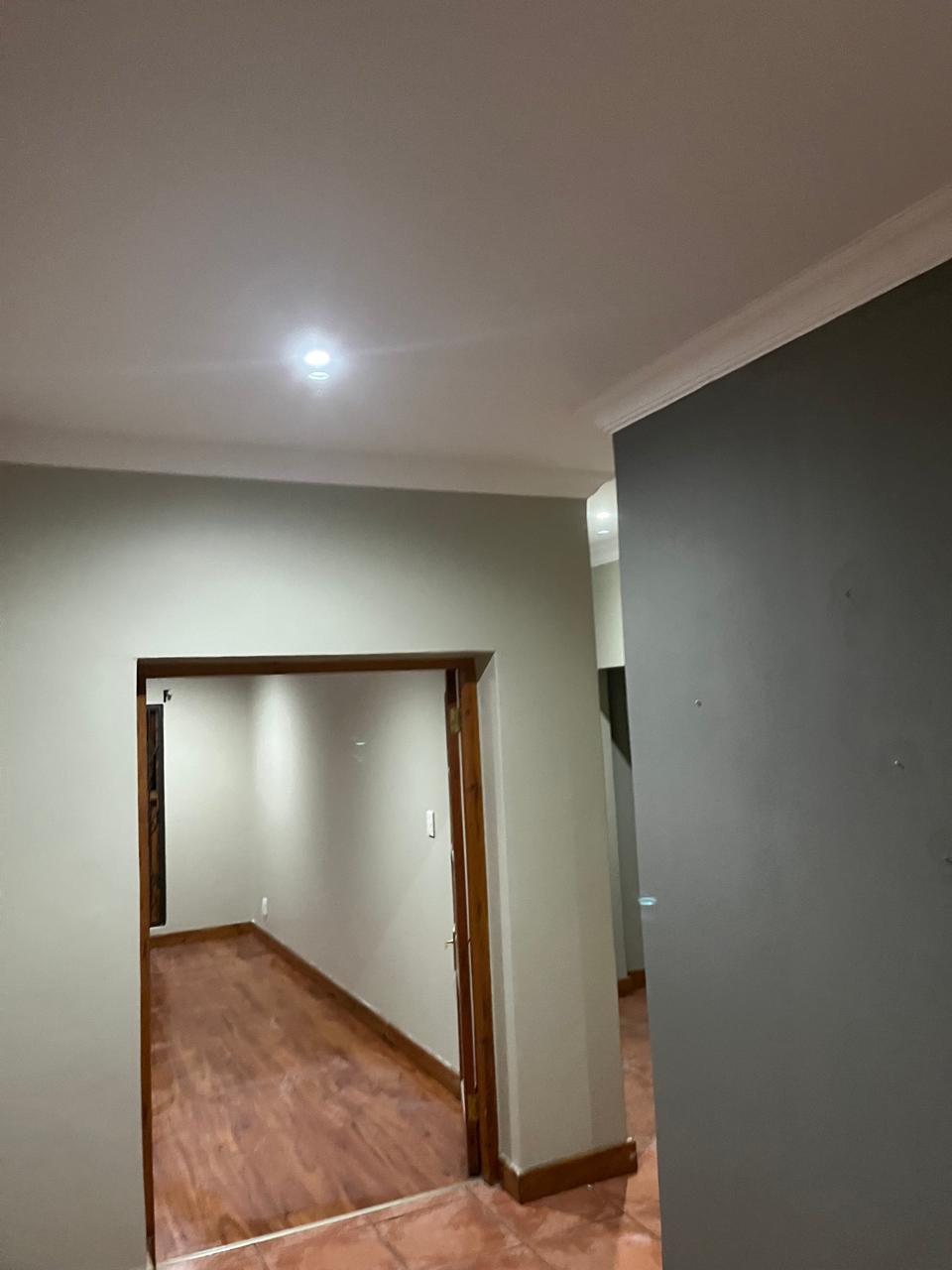 Finished interior corridor with clean ceiling and wall details
